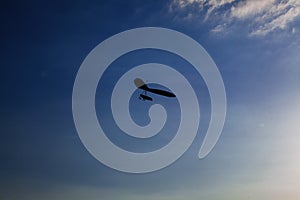 Hang-glider silhouette in sky