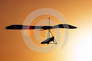 Hang-glider silhouette in sky photo