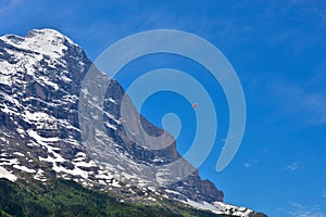 A hang glider soaring in the air near Grindelwald, Switzerland