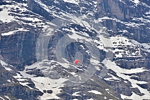 A hang glider soaring in the air near Grindelwald, Switzerland