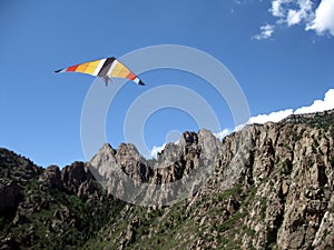 A Hang Glider Soars the Granite Pinnacles of the Sandia Mountains