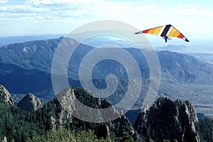 A Hang-Glider Soars over Pinnacles in the Sandia Mountains