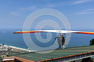 Hang glider taking off from the ramp for a double flight