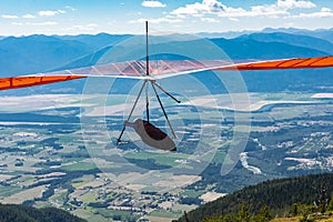 Hang gliding over valley farmlands and mountains