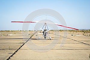 Hang-gliding, standing at dawn on the runway