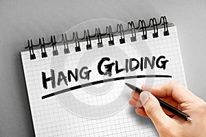Hang gliding text on notepad, concept background