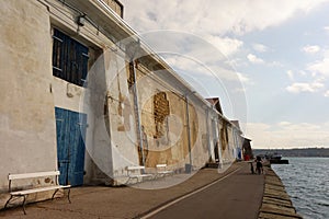 Hangar port sea worn building blue window wood door photo