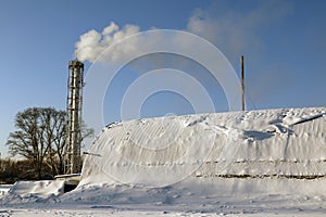 The hangar in the snow and chimney smoke