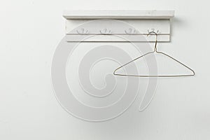 Hanger with shoulders on a white wall background