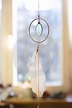 Hanger with white feather and symbol of Peace