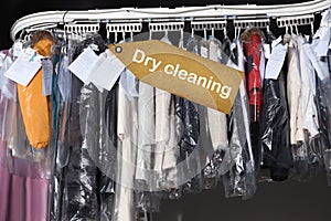 Hangers with clothes on conveyor at dry-cleaner`s