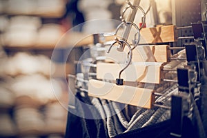 Hangers with clothes on the rail in the store. Shopping in store. Clothes on hangers in shop for sale