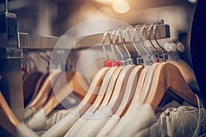 Hangers with clothes on the rail in the store. Shopping in store. Clothes on hangers in shop for sale