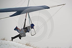 Hangglider pilot runs very fast to get airborne photo