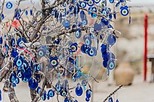 Hanging blue evil eyes Nazar Boncugu on the tree photo