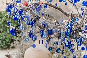 Hanging blue evil eyes Nazar Boncugu on the tree photo