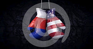 Hanging boxing gloves with the russian flag and the flag of the United States of America illustrate the tensions between the two