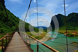 Hanging bridge with a view of green water stream in Phong Nha, Ke Bang National Park, Vietnam