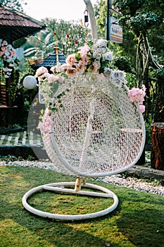 A hanging chair adorned with beautiful floral embellishments,