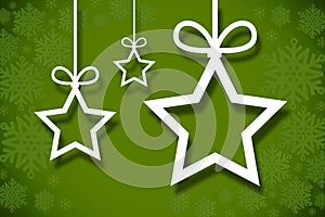 Hanging christmas decorations on green