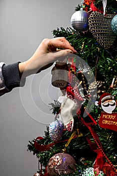Hanging Christmas decorations and ornaments in the Christmas tree