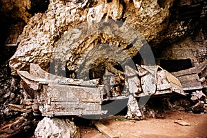 Hanging coffins, graves. Old coffin with skulls and bones nearby on a rock. Kete Kesu in Rantepao, Tana Toraja, Indonesia