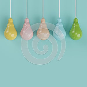 Hanging colorful pantone pastel light bulbs different idea on light blue background