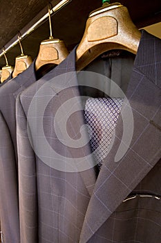 Hanging designer suits with necktie