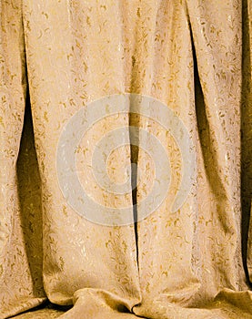 Hanging drapes of gold damask