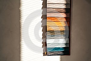 Hanging fabric samples illuminated by sunlight in modern interior