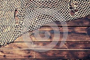 Hanging Fishnet on Wood Background