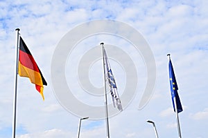hanging flags of the European Union, Germany and village Wellen
