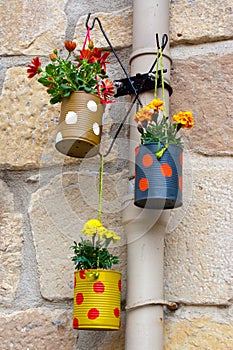 Hanging flowerpots made with cans.