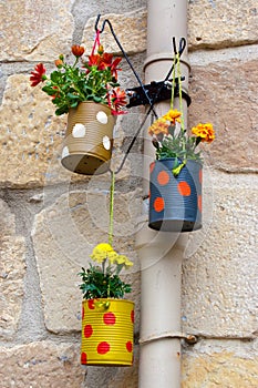 Hanging flowerpots made with cans. photo
