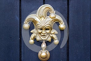 Jester or Harlequin mask as a door knocker