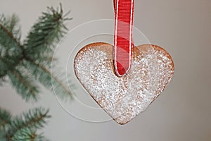 Hanging gingerbread heart with a red ribbon, christmas tree bran