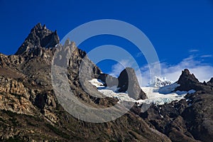 A hanging Glacier, nestled below the Granite peaks at the top of one of the mountains of the French Valley in Torres Del Paine