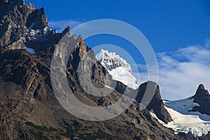 A hanging Glacier, peeking out over the forest, at the top of one of the mountains of the French Valley in Torres Del Paine Natio