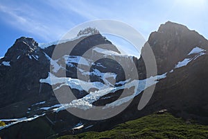 Hanging Glaciers nestled in a valley below the peaks of the mountains alongside the W walk trail in Torres Del Paine National Park