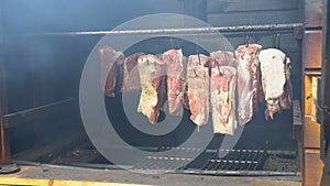 Hanging ham in the smokehouse