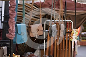 Hanging handbags in a row on a street market photo