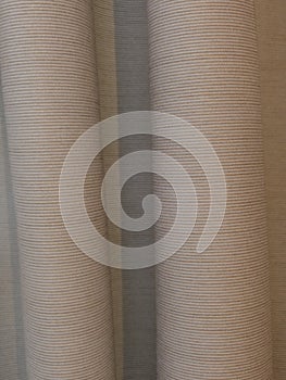 Hanging horizontally ribbed beige curtains