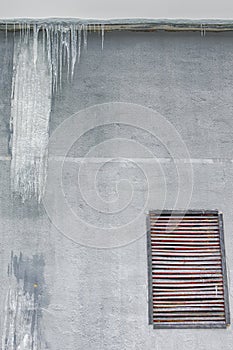 Hanging Icicles on The Building Wall During Frosty Winter Season