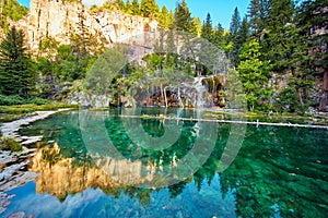 Hanging Lake with teal water and waterfalls in the mountains