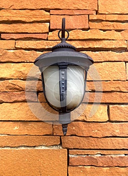 Hanging lamp on sand stone wall
