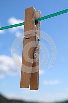 Hanging laundry clip from a green plastic rope