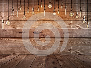 Hanging light bulb over the table and a wooden background.