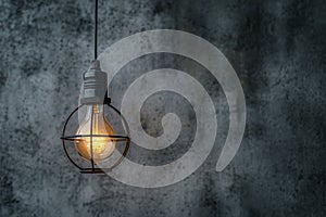 Hanging lightbulb industrial concept on cement background design