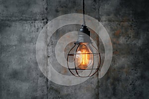 Hanging lightbulb industrial concept on cement background design