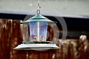 A hanging loaded bird feeder